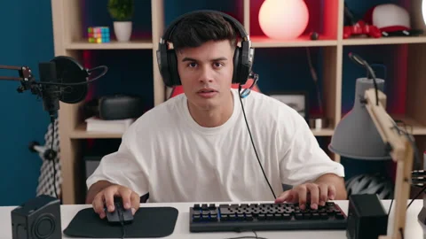 Young hispanic man streamer playing video game using computer at gaming room Video stock 219233777