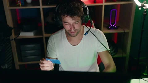Young hispanic man streamer smiling confident using credit card and computer  Stock Footage 218261684