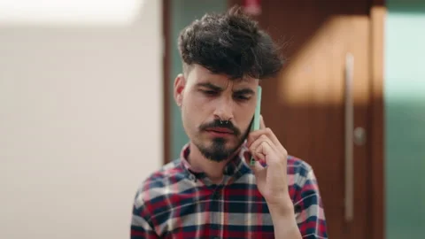 Young hispanic man talking on the smartphone at street Video stock 206555244