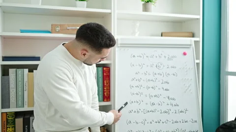 Young hispanic man teacher teaching maths lesson at library university Video stock 246134935
