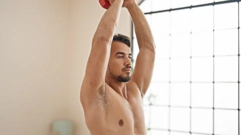 Young hispanic man training with dumbbell at bedroom Video stock 245030817