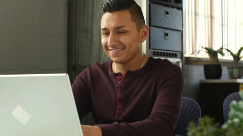 Young hispanic man using a laptop Stockbeeldmateriaal 58925737