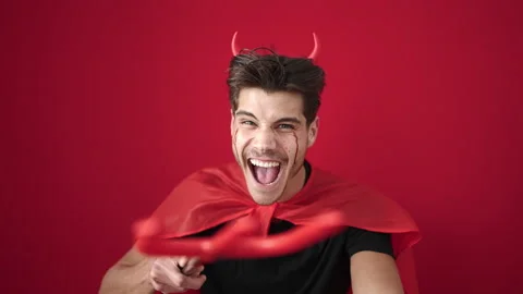 Young hispanic man wearing devil costume attack with trident over isolated .. 動画素材 232876022