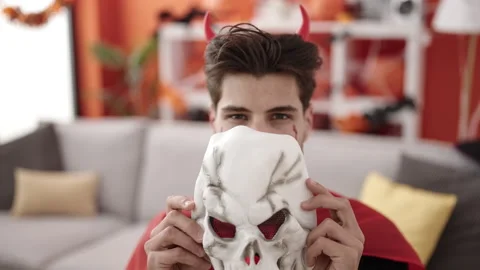 Young hispanic man wearing devil costume having halloween party at home Stock Footage 238619957