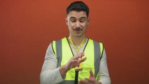 Young hispanic man wearing reflective vest volunteering against isolated or.. Stock Footage 313454280