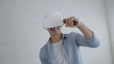 Young Hispanic man wearing virtual reality headset playing boxing game Stock Footage 166033546