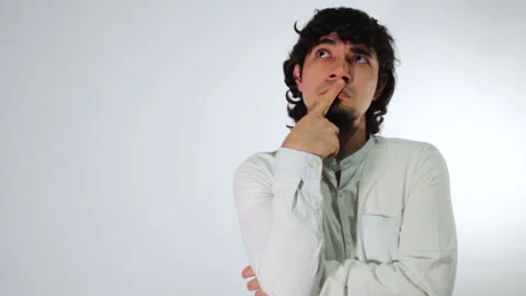 Young hispanic man on a white background posing very thoughtful Stock Footage 142846240