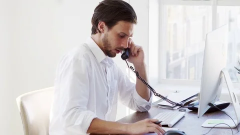 Young Hispanic man working at computer in office, close up Stock Footage 78937470