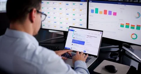 Young Hispanic Man Working On Computer, Checking Screen For Business Emails. Stock Photos