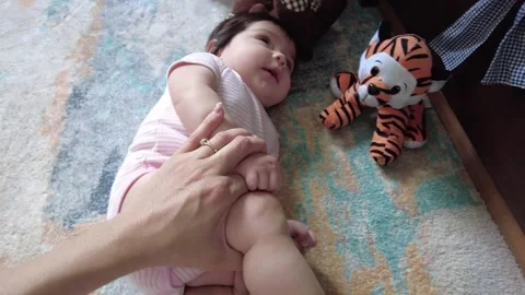 Young hispanic mom playing and exercising with her baby girl Video stock 243175075