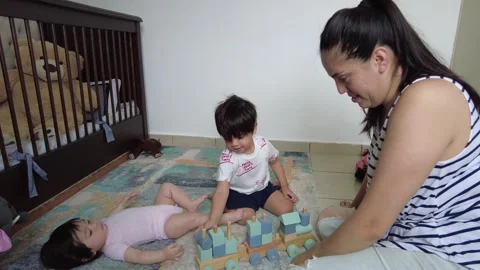 Young hispanic mother playing with her two children Stock-Footage 243174378