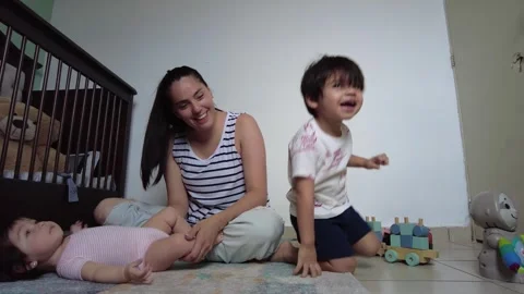 Young hispanic mother playing with her two children Stock-Footage 243174697