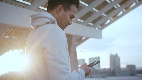 Young Hispanic thoughtful man respond to notification under the solar panel Stock Footage 105753592