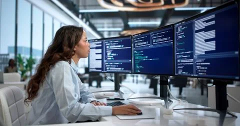 Young Hispanic Woman Coding Secure Software Systems At Office Desk Focused. Stock Photos