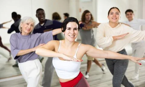 Young Hispanic woman learning dynamic dances in choreography class Stock Photos