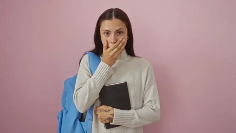 Young hispanic woman student with backpack and book, open-mouthed in amazed.. Stock Footage 294601190
