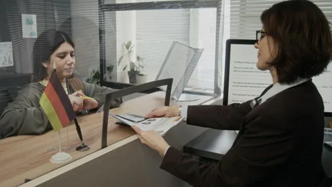 Young Hispanic Woman Submitting Documents for Student Visa at German Embassy 스톡 동영상 331515369