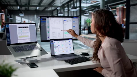 Young Hispanic Woman Working On Document Management Software At Her Laptop Stock Footage 336795834
