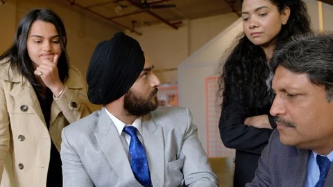 Young hot headed Indian Sikh manager berates and screams in livid and anger at h Stock Footage 101890371