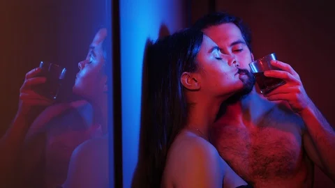 Young Hot lovers in the dark,flirting drinking alcohol.Attraction,sex Stock Footage 107032326