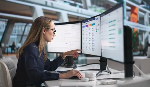 Young HR Manager Uses Computer Software To Analyze Employee Attendance Data. Stock Photos