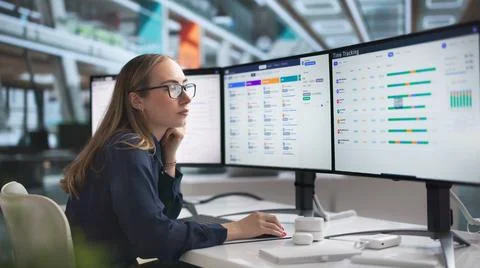 Young HR Manager Uses Computer Software To Track Employee Attendance. Фото
