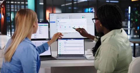 Young HR Manager Using Laptop To Process Employee Payroll And Benefits. Stock Photos