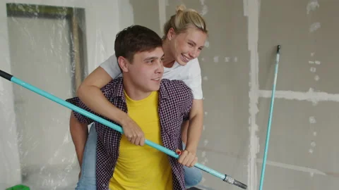 The young husband dances, rolling his wife on his back, girl hold a lengthening Stock Footage 135306992