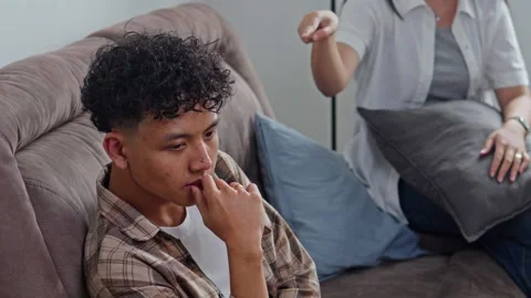 Young husband looking distressed while wife argues in background Stock Footage 331407634