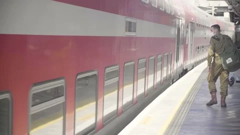 Young IDF Soldier walking by train in Israeli railway station Stock Footage 148496566