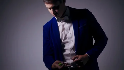 Young illusionist performing tricks with fidget spinner Stock Footage 80117748