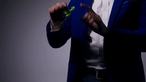Young illusionist performing tricks with fidget spinner Stock Footage 80117782