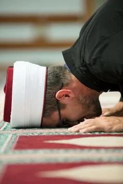 Young Imam praying inside of beautiful mosque Stock Photos