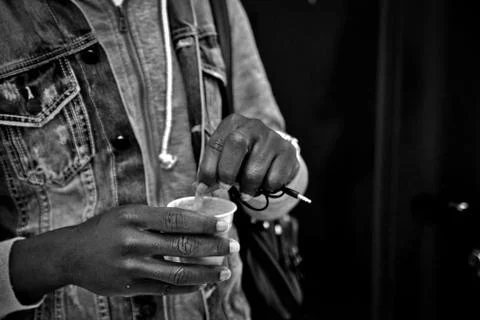 A young immigrant is taking a coffee Stock Photos