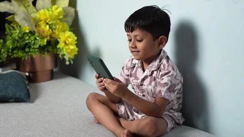 Young Indian Boy Learning on Smartphone at Home Stock Footage 339484656