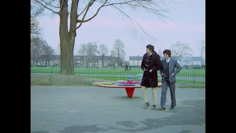 Young indian boy talking to his brother while leaving playground, 1971 Stock Footage 133381231