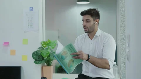 Young indian Businessman Manager checking  filling documents reports. Видео 163403109