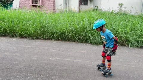 Young Indian Child Learning To Roller Skate On A Rural Road Vídeo Stock 347128070