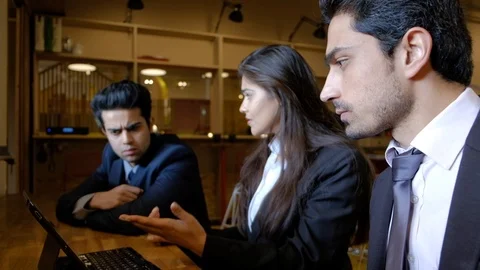 Young Indian colleagues engage together as they ideate and brainstorm on a compu Stock Footage 104794271