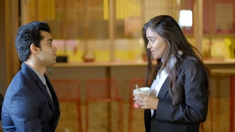 Young Indian colleagues workers facing each other discussion work as they smile  Stock Footage 104896136