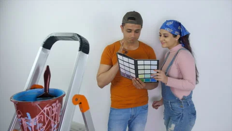 A young Indian couple checking colour shade card - home painting, home renova... Stock Footage 253178282