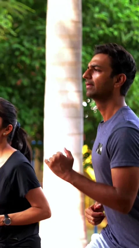 Young Indian couple doing step workout together in outdoor park outdoors Stock Footage 342843726