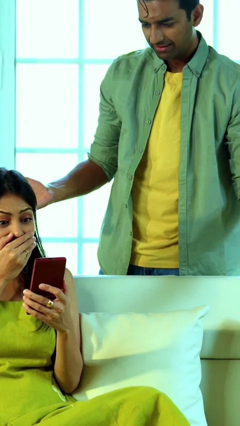 Young Indian couple sitting on sofa making online payment with card, smartphone Stock-Footage 342689234