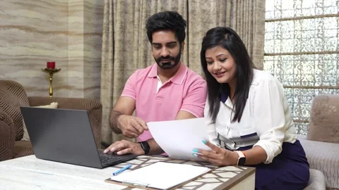 Young indian Couple using laptop manage domestic finance together sitting a.. Stock Footage 280241200