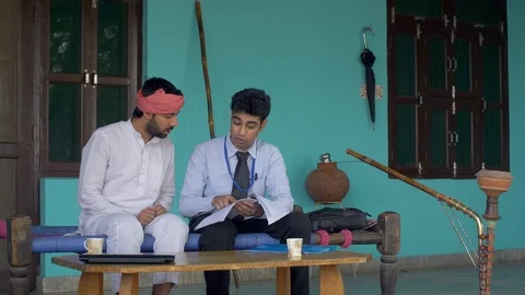 Young Indian farmer getting information about health insurance policy from an... Stock Footage 113595733