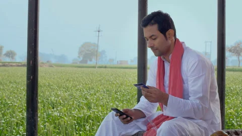 A young Indian farmer using a credit card to make an online payment through a... Video stock 154989652