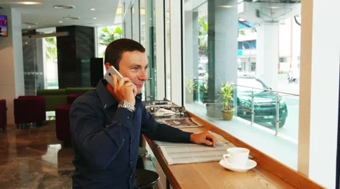 A young Indian guy in a cafe working. Business man have a job in hotel. Young Stock Footage 59730399