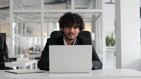 Young Indian Hispanic businessman using computer working with enthusiasm. Video stock 238587605