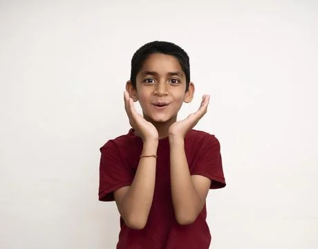 Young Indian kid acting surprised white standing on a white wall with copy sp Stock Photos