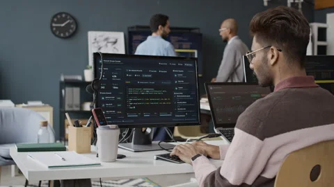 Young Indian Male Programmer Coding on Computer in IT Office Vidéo 337481550